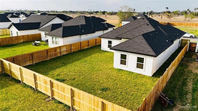 view of yard with a fenced backyard and a residential view