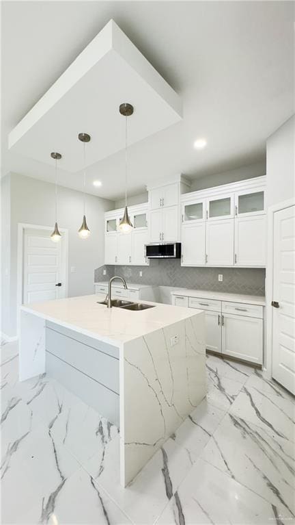 kitchen featuring recessed lighting, a sink, pendant lighting, white cabinetry, and tasteful backsplash