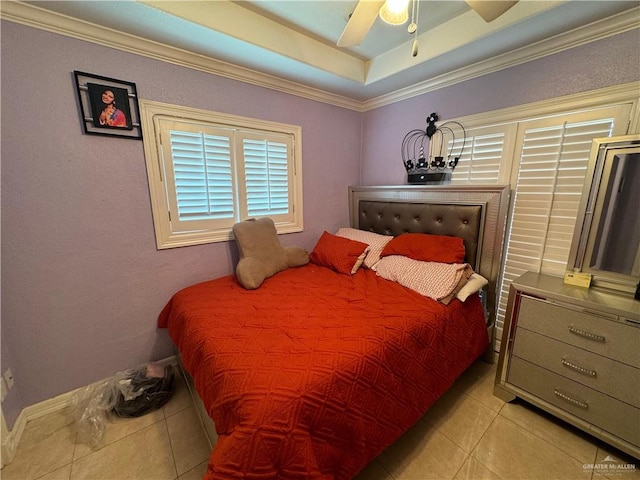 tiled bedroom featuring a raised ceiling, ceiling fan, and crown molding