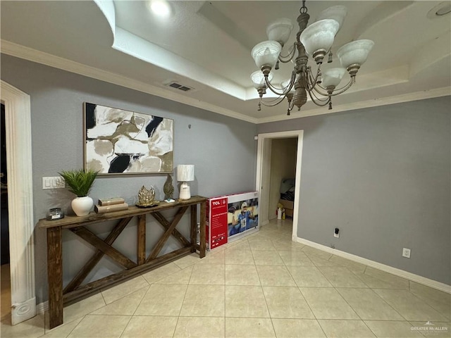 interior space featuring a tray ceiling, crown molding, and a notable chandelier