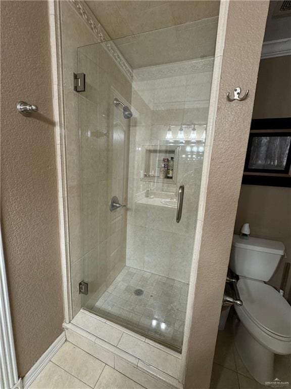 bathroom with tile patterned flooring, toilet, an enclosed shower, and ornamental molding