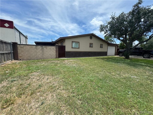 view of property exterior featuring a garage and a yard