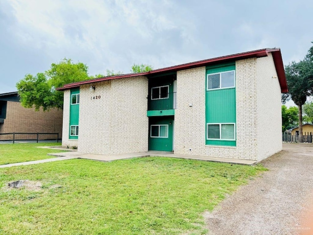1620 W Samano St, Edinburg, TX 78539 - rear view of house with a yard