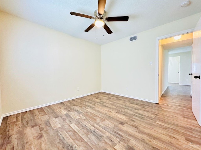 unfurnished room with ceiling fan and light hardwood / wood-style flooring