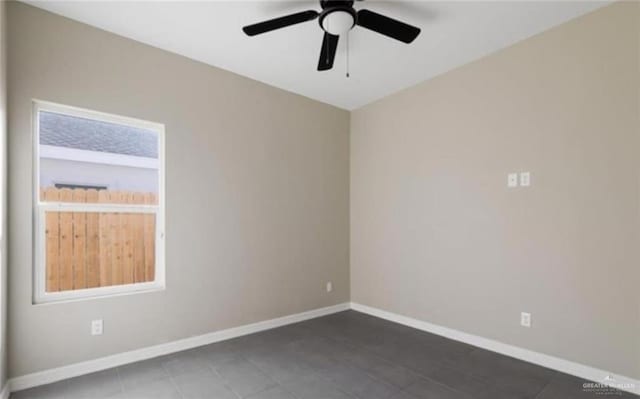 empty room with ceiling fan and a healthy amount of sunlight