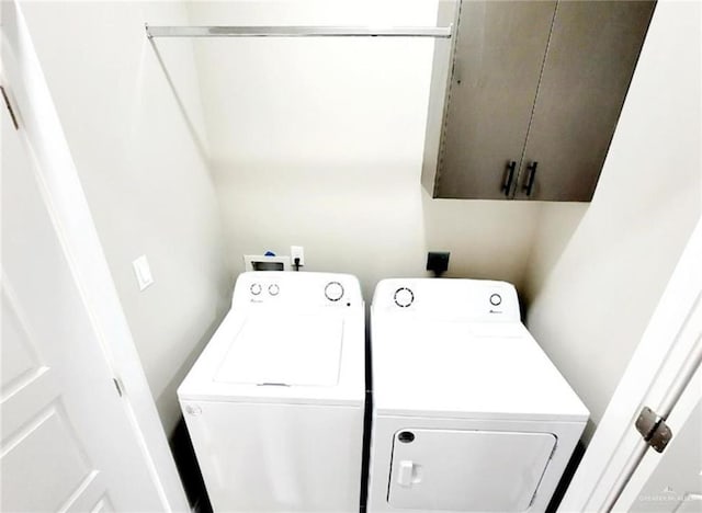 laundry room with cabinets and washing machine and clothes dryer