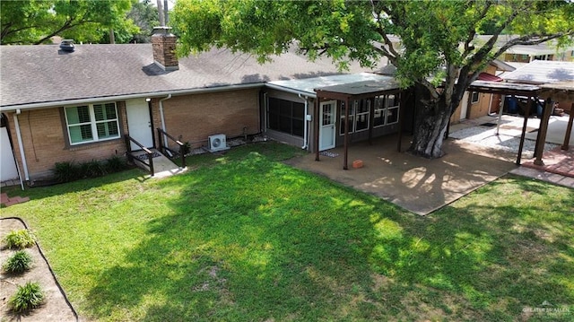 back of house with a lawn and a patio area