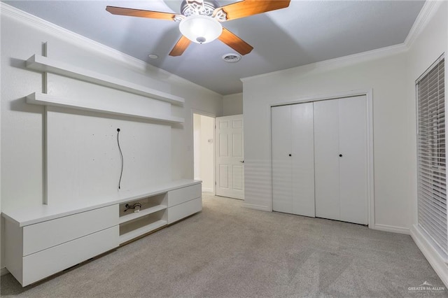 unfurnished bedroom with ceiling fan, ornamental molding, light carpet, and a closet