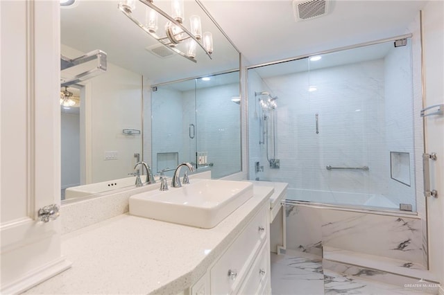 bathroom with vanity and bath / shower combo with glass door