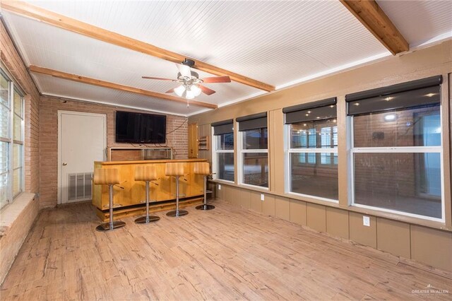 interior space featuring beamed ceiling and ceiling fan