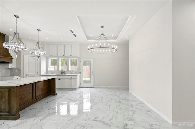 4313 Xenops Ave, Mcallen, TX 78504 - kitchen with a chandelier, baseboards, white cabinets, recessed lighting, and light marble finish flooring