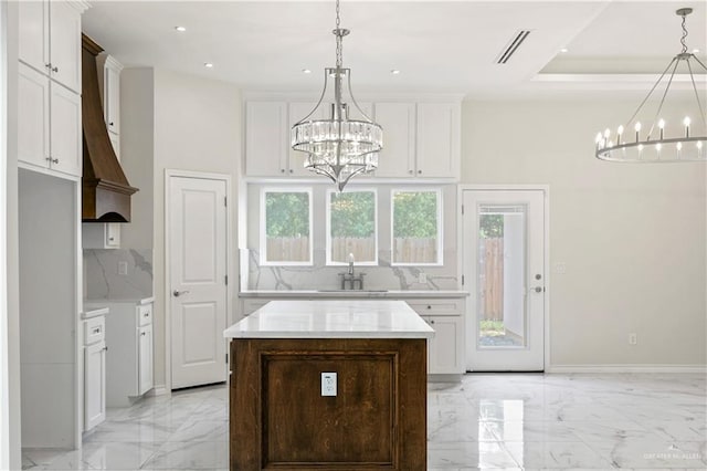 4313 Xenops Ave, Mcallen, TX 78504 - kitchen featuring a chandelier, decorative backsplash, light marble finish flooring, light countertops, and recessed lighting