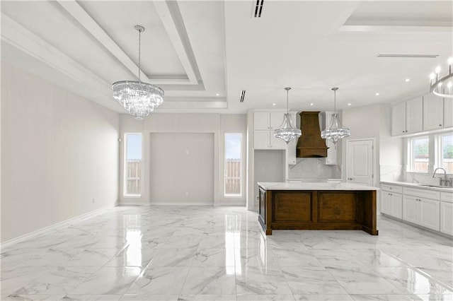 4313 Xenops Ave, Mcallen, TX 78504 - kitchen with a chandelier, a sink, custom exhaust hood, a raised ceiling, and white cabinets