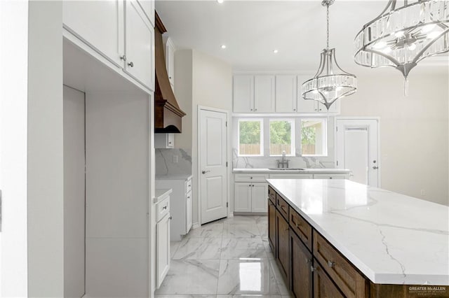 4313 Xenops Ave, Mcallen, TX 78504 - kitchen with a sink, light marble finish flooring, a chandelier, a kitchen island, and recessed lighting