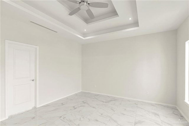 4313 Xenops Ave, Mcallen, TX 78504 - empty room featuring a tray ceiling, light marble finish flooring, a ceiling fan, baseboards, and recessed lighting