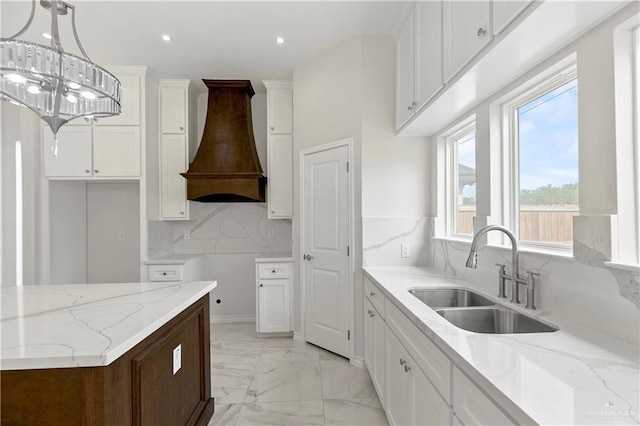 4313 Xenops Ave, Mcallen, TX 78504 - kitchen with a sink, premium range hood, light marble finish floors, light stone countertops, and white cabinets