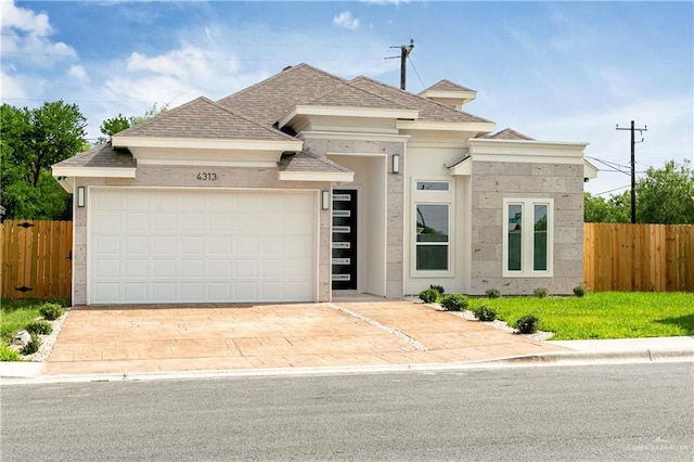 4313 Xenops Ave, Mcallen, TX 78504 - view of front facade featuring an attached garage, a shingled roof, stucco siding, and driveway