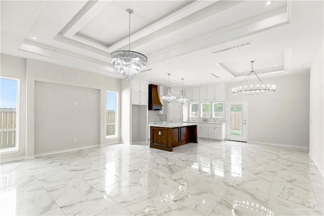 4313 Xenops Ave, Mcallen, TX 78504 - unfurnished living room featuring a raised ceiling, a chandelier, baseboards, light marble finish flooring, and recessed lighting