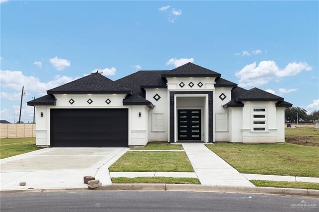 view of front of house with a front lawn and a garage