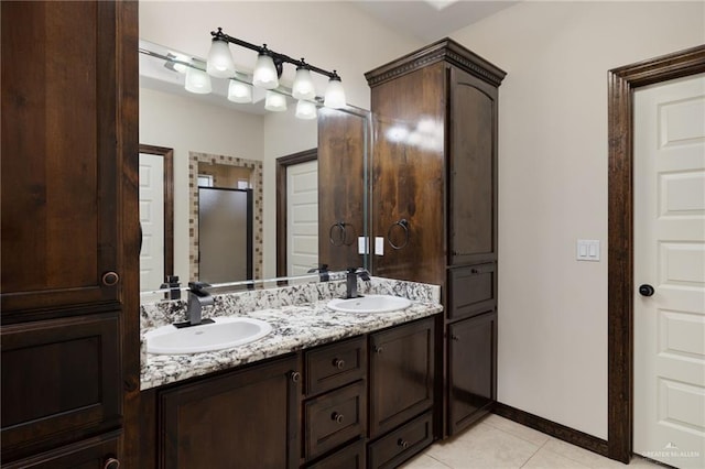 bathroom with tile patterned floors, double vanity, a sink, and a stall shower
