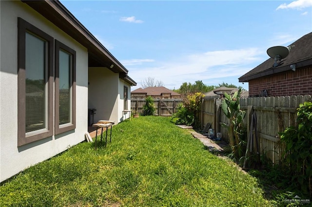 view of yard with a fenced backyard