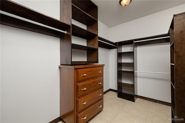 spacious closet with light tile patterned floors