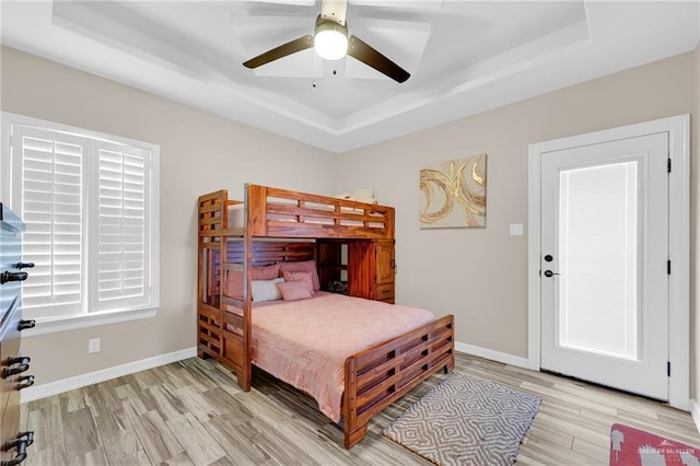 3705 Joycee Dr, Mission, TX 78572 - bedroom with a tray ceiling, light wood-style floors, and a ceiling fan