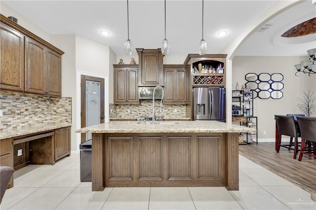 3705 Joycee Dr, Mission, TX 78572 - kitchen featuring appliances with stainless steel finishes, light tile patterned floors, decorative backsplash, light stone counters, and recessed lighting