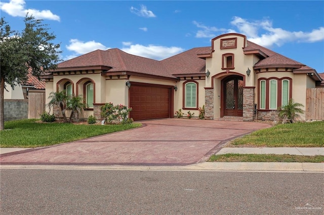 3705 Joycee Dr, Mission, TX 78572 - mediterranean / spanish home featuring stucco siding, driveway, a garage, and french doors