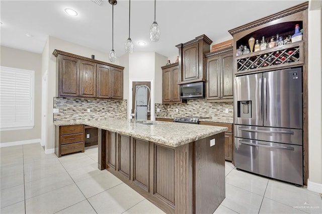 3705 Joycee Dr, Mission, TX 78572 - kitchen featuring stainless steel appliances, light tile patterned floors, tasteful backsplash, a kitchen island with sink, and recessed lighting