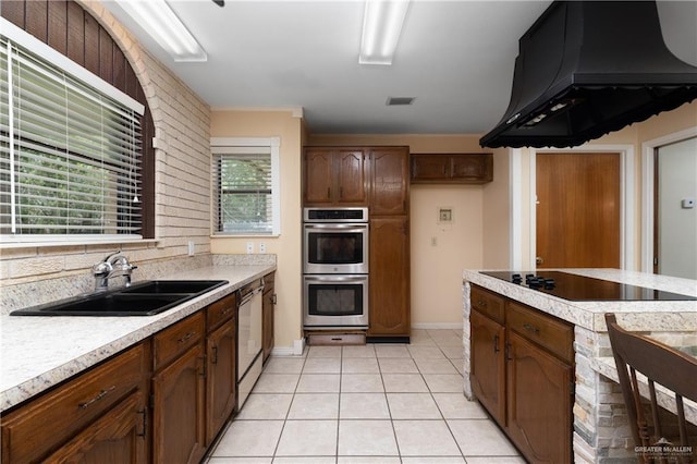 509 Lincoln Ln, La Feria, TX 78559 - kitchen with a sink, custom exhaust hood, stainless steel appliances, light countertops, and light tile patterned flooring
