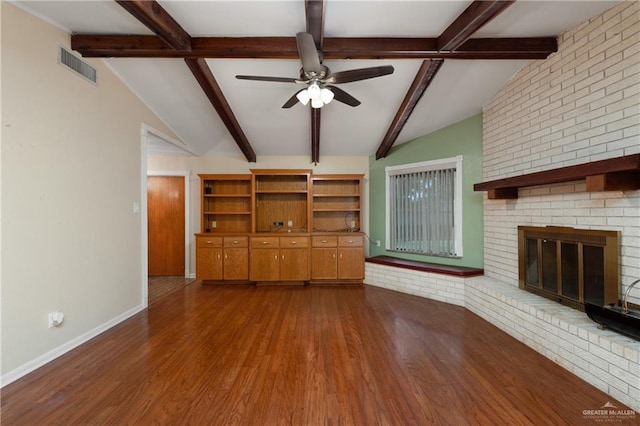 509 Lincoln Ln, La Feria, TX 78559 - unfurnished living room with ceiling fan, dark wood-style floors, a fireplace, and baseboards