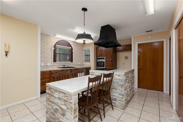 509 Lincoln Ln, La Feria, TX 78559 - kitchen with stainless steel oven, custom exhaust hood, light tile patterned flooring, light countertops, and a sink
