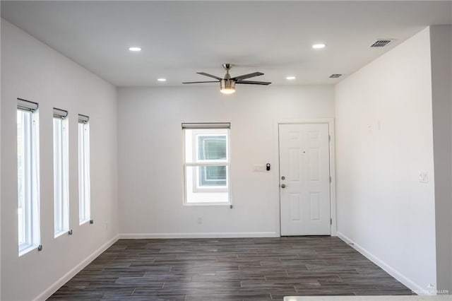 unfurnished room with dark hardwood / wood-style floors and ceiling fan