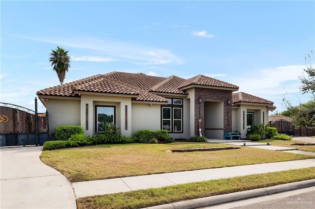 mediterranean / spanish-style house featuring a front lawn