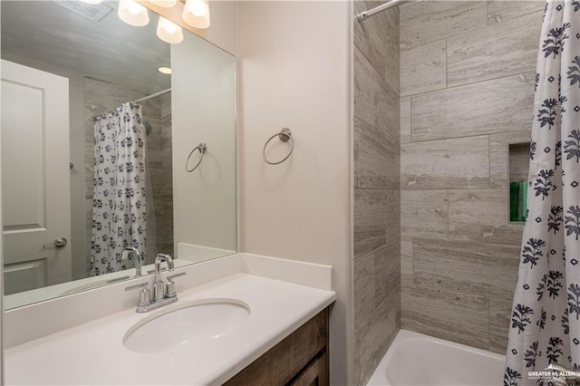 bathroom with visible vents, shower / tub combo with curtain, and vanity