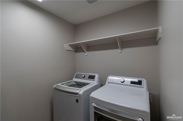 laundry room with washer and clothes dryer, laundry area, and visible vents