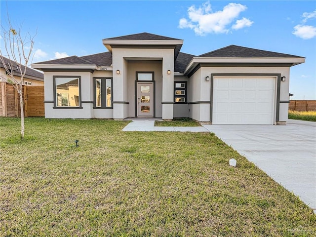prairie-style home featuring stucco siding, a front lawn, fence, concrete driveway, and an attached garage