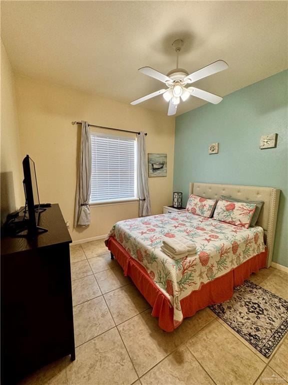 tiled bedroom featuring ceiling fan