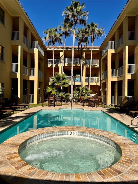 view of pool featuring a hot tub