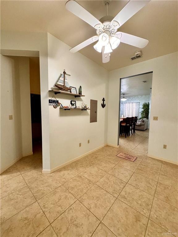 spare room with electric panel, ceiling fan, and light tile patterned flooring