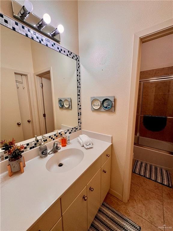 bathroom with tile patterned flooring, vanity, and a shower with shower door