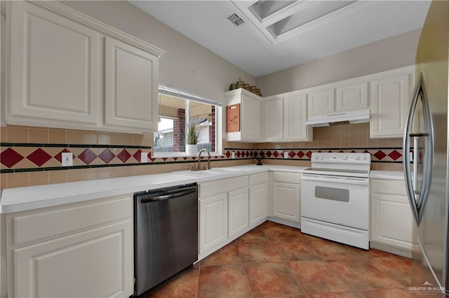 kitchen featuring backsplash, sink, white cabinets, and appliances with stainless steel finishes