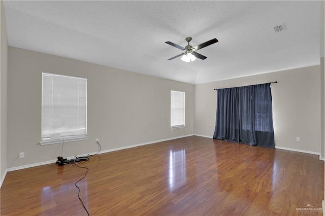 spare room featuring ceiling fan, wood-type flooring, and a textured ceiling