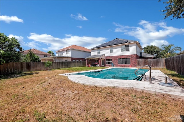 view of swimming pool featuring a yard and a patio