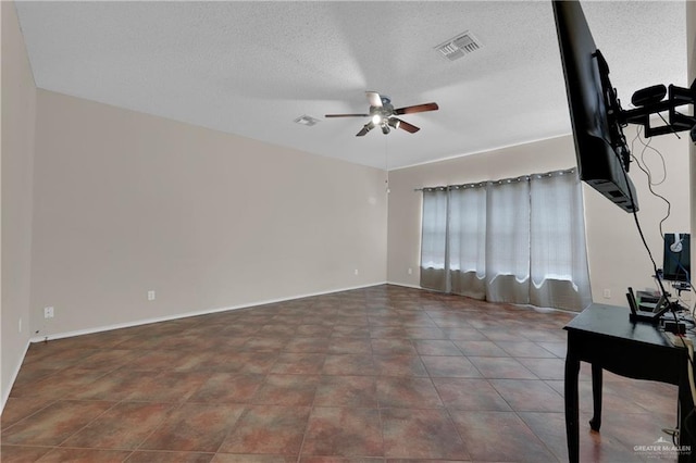 interior space featuring ceiling fan and a textured ceiling