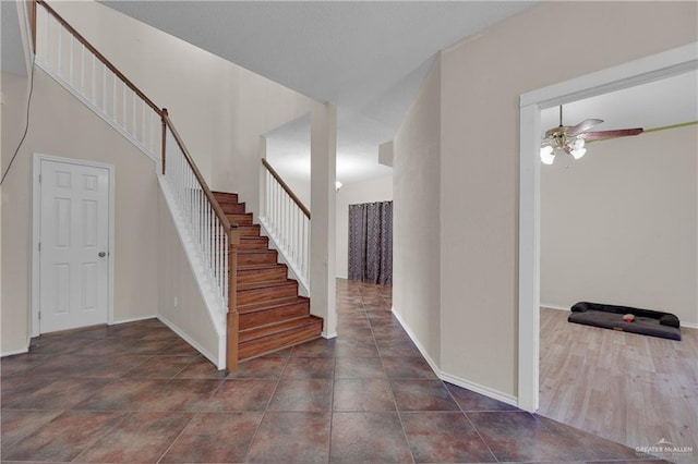 foyer entrance with dark hardwood / wood-style floors and ceiling fan