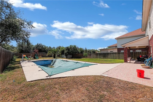 view of swimming pool with a lawn, a playground, and a patio