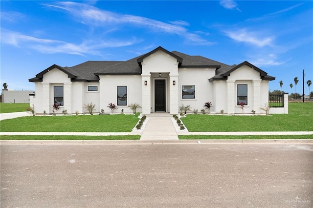 modern inspired farmhouse with a front lawn, roof with shingles, and stucco siding