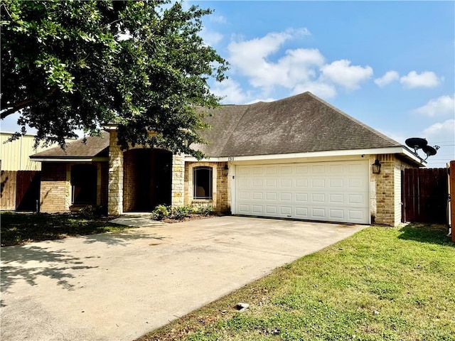 1311 Anahi St, Alamo, TX 78516 - ranch-style house with driveway, brick siding, a garage, and a shingled roof